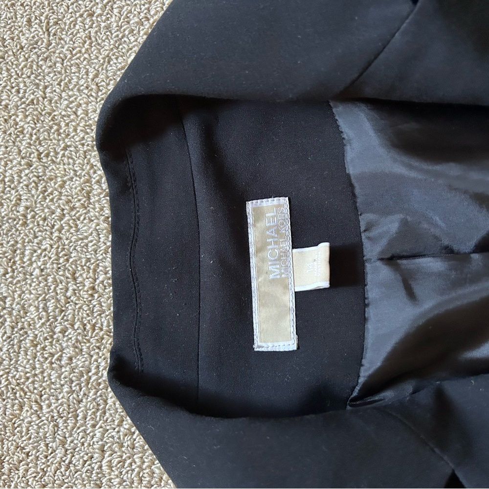 Black, Michael Cors blazer. Fringed at the 3/4 sleeves. Iron stain on one sleeve